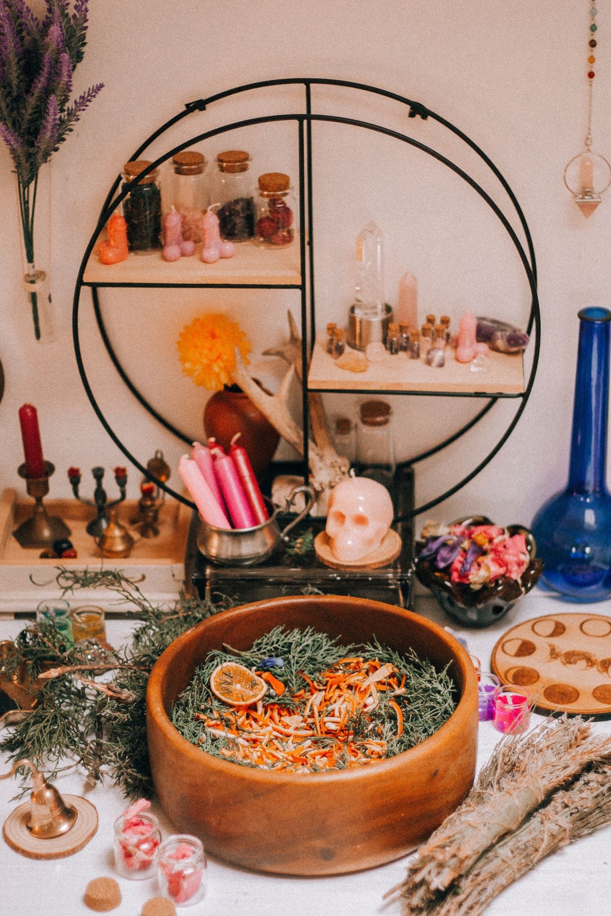 Candles, dried herbs and orange peel on a personal ritual table