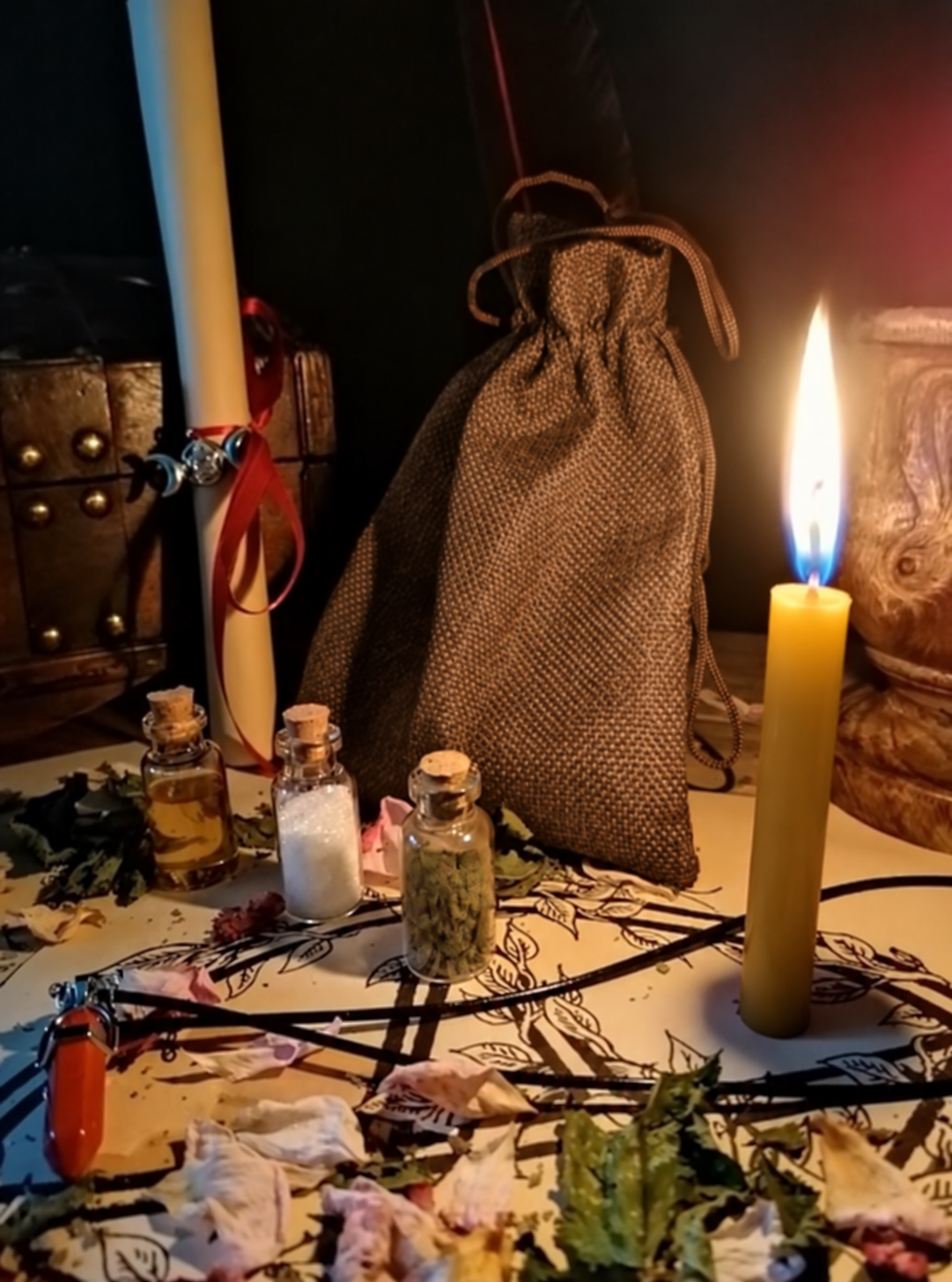Illustrative scene for Open Your Career Path with a candle, dried plants and small glass vials, adapted from the shared ritual setting.