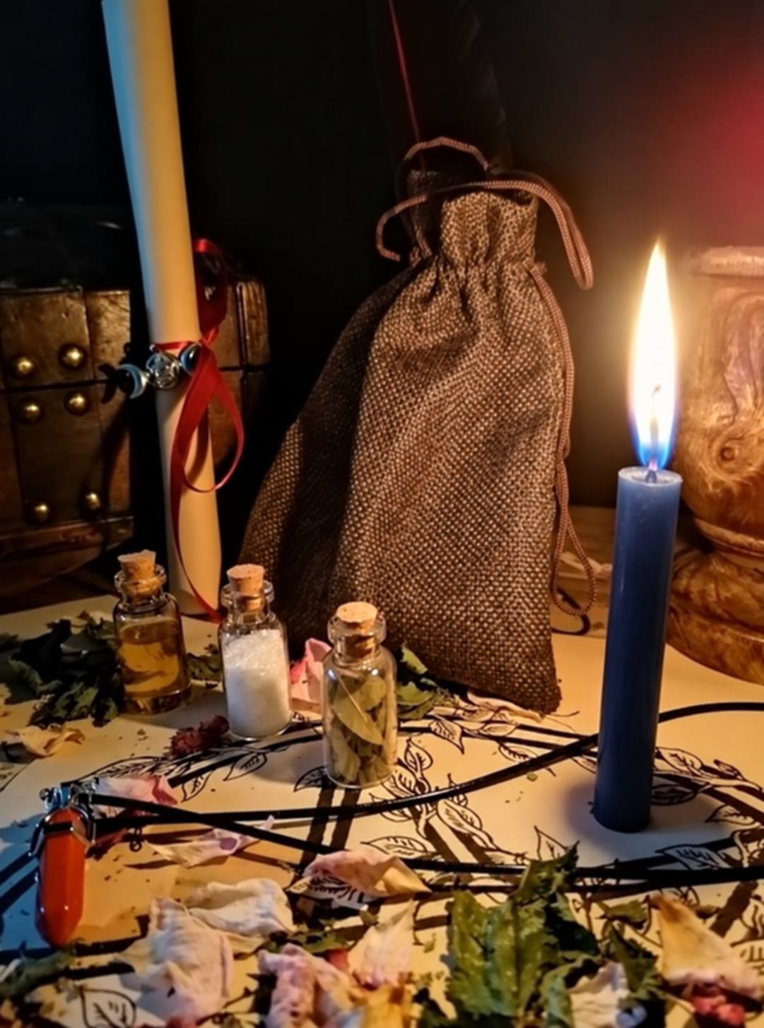 Illustrative scene for Justice Spell with a candle, dried plants and small glass vials, adapted from the shared ritual setting.