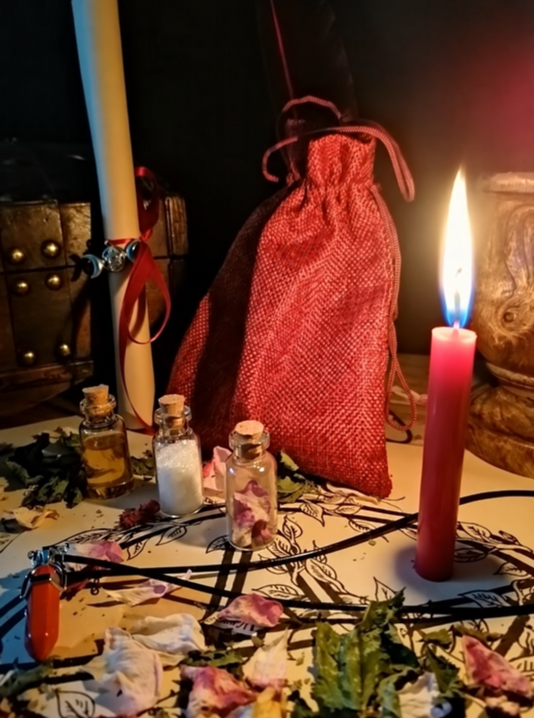 Illustrative scene for Love Spell with a candle, dried plants and small glass vials, adapted from the shared ritual setting.