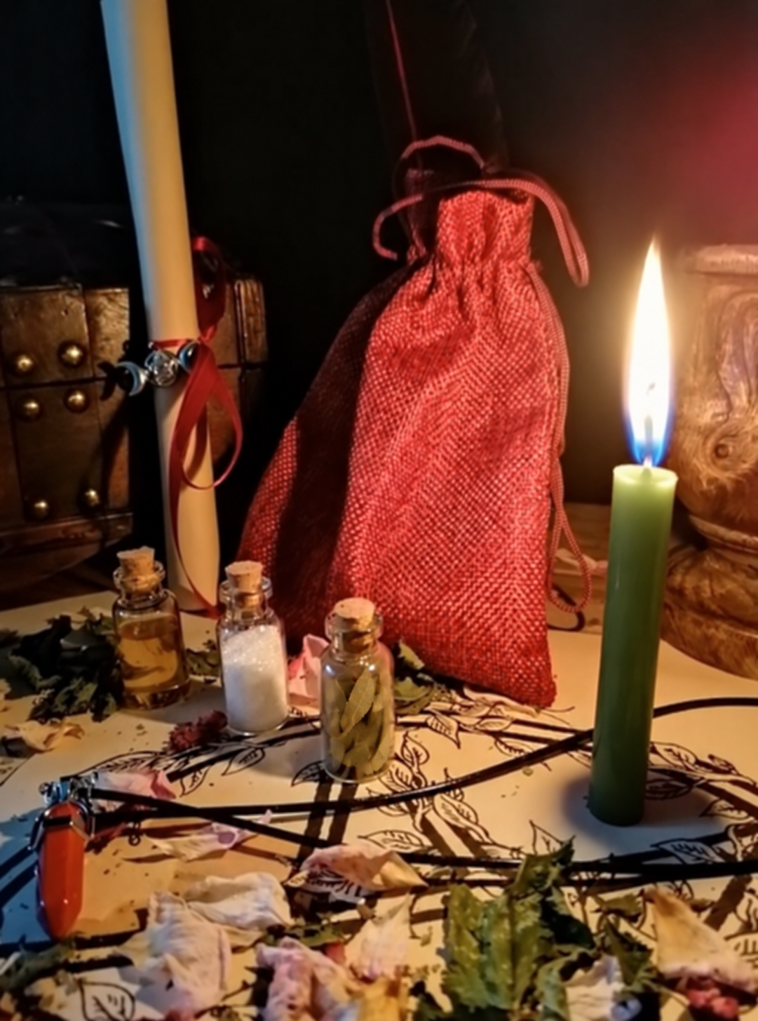 Illustrative scene for Luck Activation Spell with a candle, dried plants and small glass vials, adapted from the shared ritual setting.