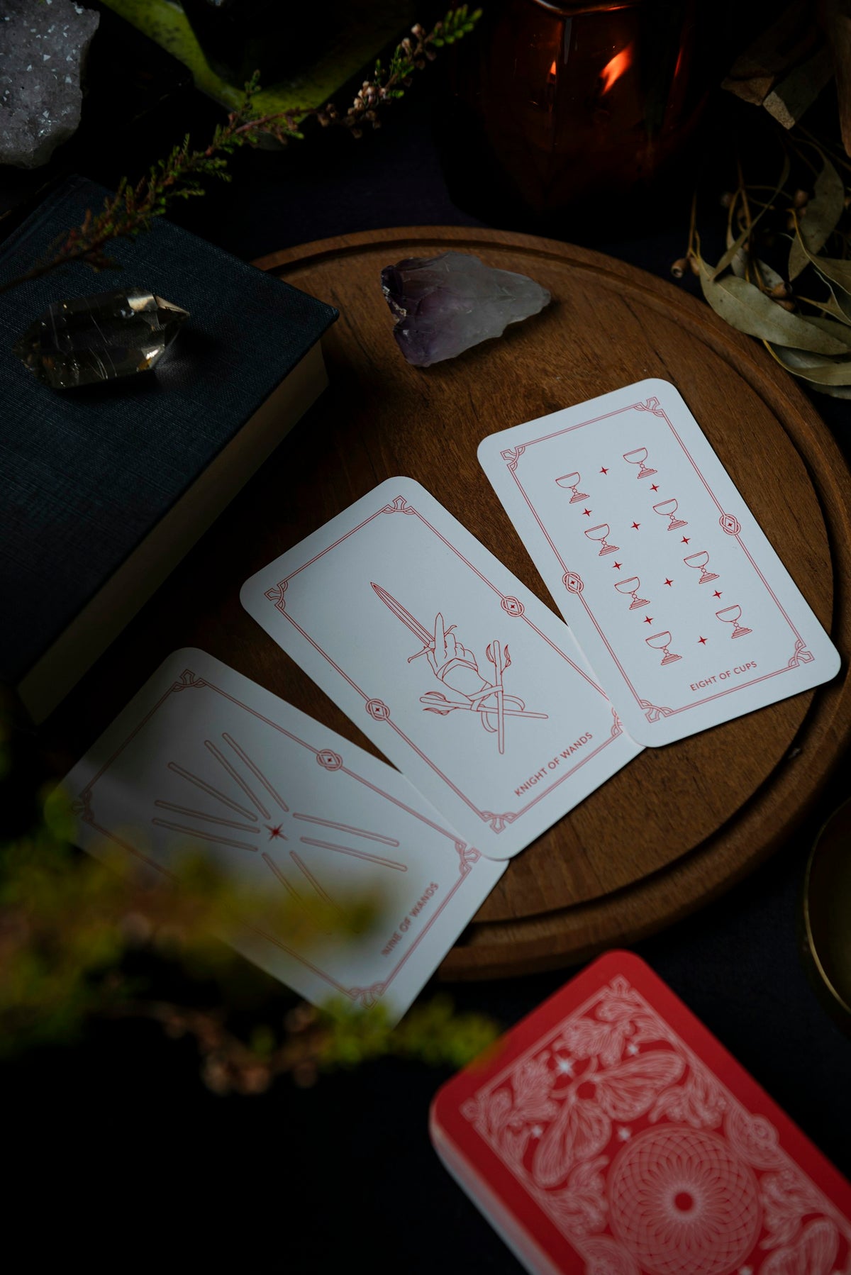 Tarot cards beside a candle — atmosphere photograph by Joanna Kosinska